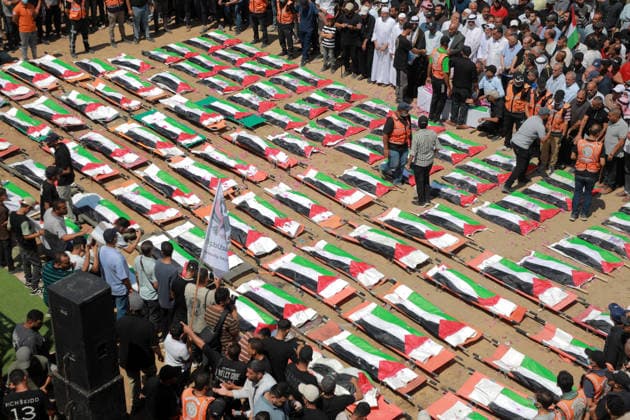 Palestinians Hold Mass Funeral For 112 Family Members In Gaza - Palestine A photograph shows the flag-covered remains of members of the Abu Sharia and al-Hasayna families, recently recovered from the rubble of residential buildings in the al-Sabra neighbourhood which were struck by Israeli bombardments in November 2023, during a mass funeral in Gaza City on August 4, 2026. An October ceasefire remains in place between Israel and Hamas, but it has not halted the violence in Gaza. Photo by Photo by Rizek ELdremle ABACAPRESS.COM Gaza City Palestine  Copyright: xEldremlexRizek ABACAx