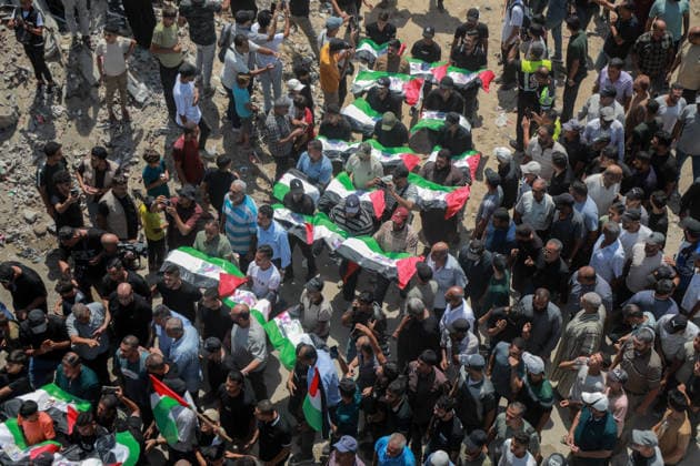 Palestinians Hold Mass Funeral For 112 Family Members In Gaza - Palestine A photograph shows the flag-covered remains of members of the Abu Sharia and al-Hasayna families, recently recovered from the rubble of residential buildings in the al-Sabra neighbourhood which were struck by Israeli bombardments in November 2023, during a mass funeral in Gaza City on August 4, 2026. An October ceasefire remains in place between Israel and Hamas, but it has not halted the violence in Gaza. Photo by Photo by Rizek ELdremle ABACAPRESS.COM Gaza City Palestine  Copyright: xEldremlexRizek ABACAx