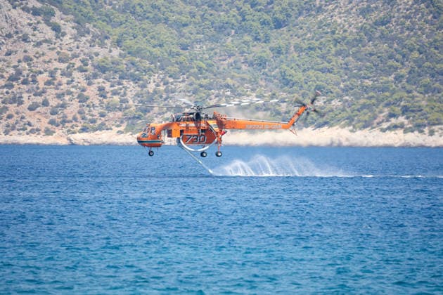 Wildfire continues for fourth day in Psatha, Greece PSATHA, GREECE - AUGUST 04: Helicopters refill with water to continue firefighting operations as a wildfire burns for the fourth consecutive day in Psatha, Greece, on August 04, 2026. Thousands of square meters of forest, along with several houses, have been destroyed. Although the fire fronts have eased after four days of intense burning, authorities remain on alert. Aris Oikonomou Anadolu Psatha Greece. Editorial use only. Please get in touch for any other usage.  Copyright: x2026xAnadoluxArisxOikonomoux