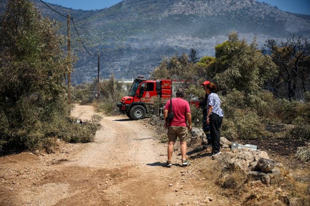 Wildfire continues for fourth day in Psatha, Greece PSATHA, GREECE - AUGUST 04: Residents speak with a firefighter while attempting to access their house, fearing it may have been destroyed by a wildfire in Psatha, Greece, on August 04, 2026. Thousands of square meters of forest, along with several houses, have been destroyed. Although the fire fronts have calmed after four days of intense burning, authorities remain on alert. Aris Oikonomou Anadolu Psatha Greece. Editorial use only. Please get in touch for any other usage.  Copyright: x2026xAnadoluxArisxOikonomoux