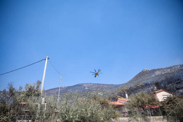 Wildfire continues for fourth day in Psatha, Greece PSATHA, GREECE - AUGUST 04: Helicopters continue firefighting operations as a wildfire burns for the fourth consecutive day in Psatha, Greece, on August 04, 2026. Thousands of square meters of forest, along with several houses, have been destroyed. Although the fire fronts have calmed after four days of intense burning, authorities remain on alert. Aris Oikonomou Anadolu Psatha Greece. Editorial use only. Please get in touch for any other usage.  Copyright: x2026xAnadoluxArisxOikonomoux