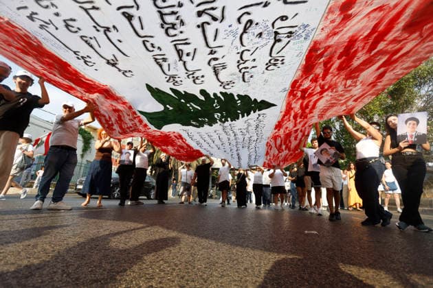 August 4, 2026, Beirut, Beirut, lebanon: Families of victims of the 2020 Beirut Port explosion take part in a central memorial march marking the sixth anniversary of the disaster in Beirut, Lebanon, on August 4, 2026. The march begins at the Beirut Fire Brigade while a second procession starts from Martyrs Square, with both converging near the Emigrant Statue facing the Beirut Port. Participants carry portraits of their relatives who were killed in the massive explosion as they continue to demand truth and justice Beirut lebanon - ZUMAb339 20260804_znp_b339_010 Copyright: xAbdulxKaderxAlxBayx