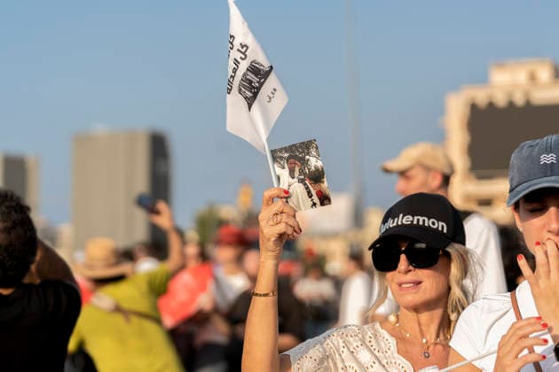 Beirut Lebanon Blast Anniversary A woman holds a flag and a portrait among the crowd during a commemoration marking the sixth anniversary of the Beirut port explosion in Beirut, Lebanon on August 4, 2026. The blast killed more than 220 people, injured thousands and displaced hundreds of thousands, while victims™ families continue to demand justice and accountability. Beirut Beirut Lebanon Copyright: xSilviaxCasadeix