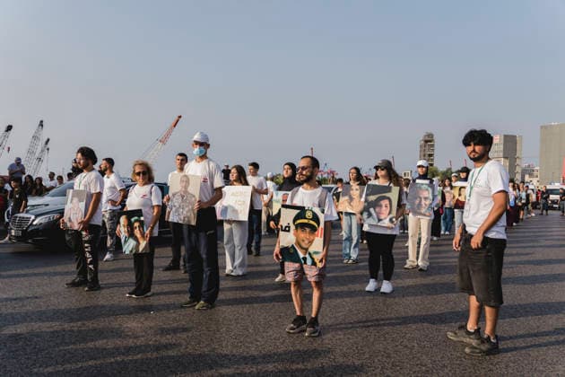 Beirut Port Blast Anniversary Commemoration Participants carrying portraits of people killed in the Beirut Port explosion stand together during a commemoration marking its sixth anniversary in Beirut, Lebanon, on August 4, 2026. The August 4, 2020 blast, caused by ammonium nitrate stored at the port, killed more than 200 people, injured thousands and devastated large parts of the Lebanese capital. Beirut Beirut Lebanon Copyright: xManonxRocax