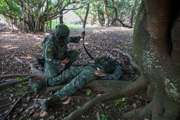 Taiwan kicks off Han-Kuang military exercises as tensions with China rise PENGHU COUNTY, TAIWAN - AUGUST 5: A Taiwanese Army soldier applies tourniquet on his gun-wounded fellow, during an operation simulating a response to grey-zone attacks on key infrastructure by Chinese special agents, as part of the Han-Kuang military exercise, at a power station in Penghu County, Taiwan on August 5, 2026. The Han-Kuang exercises, which kicked off today, will last for 10-days with different unscripted drills simulating response to a possible invasion by China, amid Beijing s increasing military activities around the Taiwan Strait and the South China Sea. Daniel Ceng Anadolu Penghu County Taiwan. Editorial use only. Please get in touch for any other u  Copyright: x2026xAnadoluxDanielxCengx