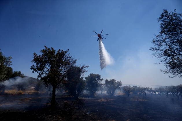 August 5, 2026, Koropi, Greece: Firefighters battle a wildfire in the Koropi area, southeast of Athens, as helicopters carry out repeated water drops to contain the flames. Ground crews worked alongside aerial firefighting units to prevent the fire from spreading amid dry conditions and strong winds. Koropi Greece - ZUMAv62_ 20260805_zaf_v62_011 Copyright: xAristidisxVafeiadakisx