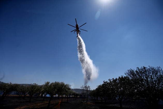 August 5, 2026, Koropi, Greece: Firefighters battle a wildfire in the Koropi area, southeast of Athens, as helicopters carry out repeated water drops to contain the flames. Ground crews worked alongside aerial firefighting units to prevent the fire from spreading amid dry conditions and strong winds. Koropi Greece  - ZUMAv62_ 20260805_zaf_v62_030 Copyright: xAristidisxVafeiadakisx