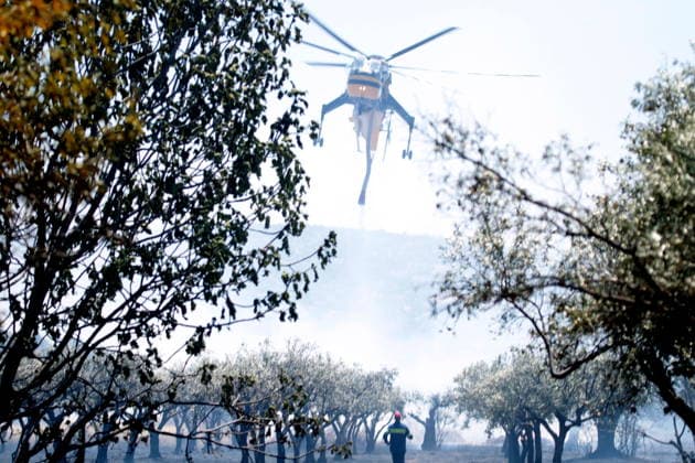 August 5, 2026, Koropi, Greece: Firefighters battle a wildfire in the Koropi area, southeast of Athens, as helicopters carry out repeated water drops to contain the flames. Ground crews worked alongside aerial firefighting units to prevent the fire from spreading amid dry conditions and strong winds. Koropi Greece - ZUMAv62_ 20260805_zaf_v62_037 Copyright: xAristidisxVafeiadakisx
