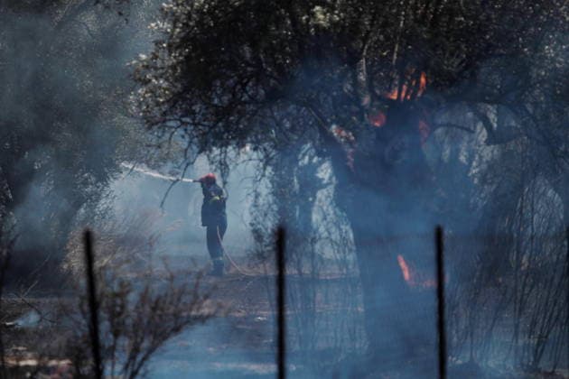 August 5, 2026, Koropi, Greece: Firefighters battle a wildfire in the Koropi area, southeast of Athens, as helicopters carry out repeated water drops to contain the flames. Ground crews worked alongside aerial firefighting units to prevent the fire from spreading amid dry conditions and strong winds. Koropi Greece  - ZUMAv62_ 20260805_zaf_v62_062 Copyright: xAristidisxVafeiadakisx