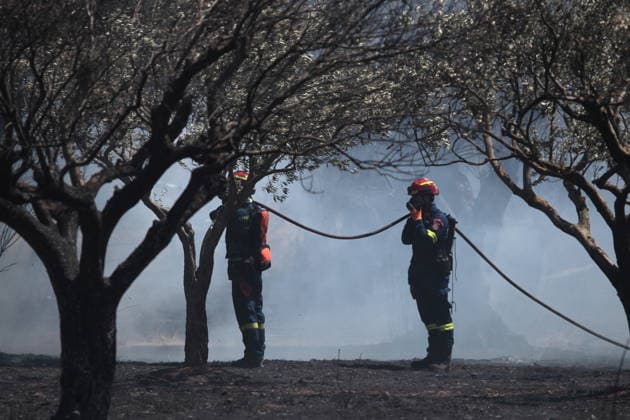August 5, 2026, Koropi, Greece: Firefighters battle a wildfire in the Koropi area, southeast of Athens, as helicopters carry out repeated water drops to contain the flames. Ground crews worked alongside aerial firefighting units to prevent the fire from spreading amid dry conditions and strong winds. Koropi Greece  - ZUMAv62_ 20260805_zaf_v62_089 Copyright: xAristidisxVafeiadakisx