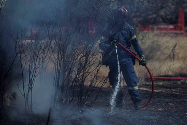 August 5, 2026, Koropi, Greece: Firefighters battle a wildfire in the Koropi area, southeast of Athens, as helicopters carry out repeated water drops to contain the flames. Ground crews worked alongside aerial firefighting units to prevent the fire from spreading amid dry conditions and strong winds. Koropi Greece - ZUMAv62_ 20260805_zaf_v62_076 Copyright: xAristidisxVafeiadakisx