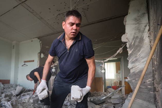 RUSSIA, DONETSK - AUGUST 5, 2026: People clear the debris in a gastroenterology ward of Donetsk City Clinical Hospital No 7 following a Ukrainian drone strike. The attack left one patient dead and two others injured. Dmitry Yagodkin TASS  95820410