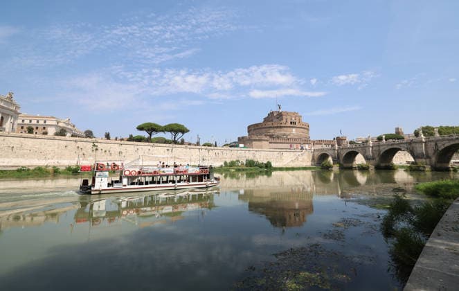 (260805) -- ROME, Aug. 5, 2026 -- A ship is seen on the Tiber River near Castel Sant Angelo in Rome, Italy, Aug. 5, 2026. Italy is battling its fourth major heatwave of the summer, with temperatures climbing above 40 degrees Celsius in parts of the country, and a record number of cities placed under the highest heat alert. Authorities are stepping up emergency measures amid mounting health, wildfire and agricultural concerns. The latest heatwave reached its peak on Monday, when the Health Ministry placed 25 of the country s 27 monitored cities under red alert, the highest warning level possible issued for extreme heat. ) ITALY-ROME-TIBER RIVER-HEAT WAVE WangxKaiyan 