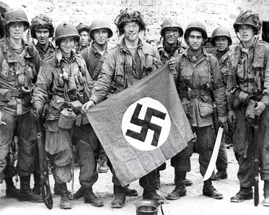American paratroopers, among the first to make successful landings on European continent, holding Nazi flag captured in village assault, Utah Beach, Saint-Marcouf, Normandy, France, Werner, U.S. Army Signal Corps, June 8, 1944  Copyright: xCircaxImagesx ghi-circa14426