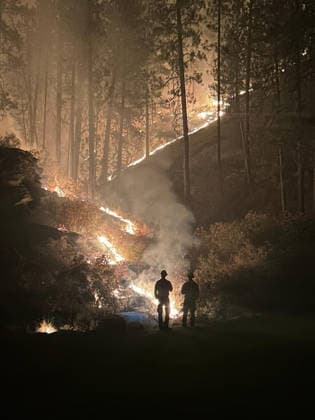 August 5, 2026, Spokane, Wa, United States: Wildland fire crew with Task Force Utah, work through the night to contain the fires in a forested area at the Autumn Lane Fire, extinguishing the remaining hot spots, August 4, 2026 near Spokane, Washington. The Autumn Lane Fire is now the largest of the three Spokane Complex fires. Spokane United States - ZUMAp138 20260805_zaa_p138_016 Copyright: xHandout UsxForestx