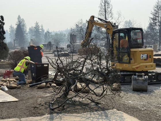 August 5, 2026, Spokane, Wa, United States: A city worker turns off water at the destroyed homes, after flames passed through from the Old Trails fire, August 4, 2026 near Spokane, Washington. Spokane United States - ZUMAp138 20260805_zaa_p138_021 Copyright: xHandout UsxForestx