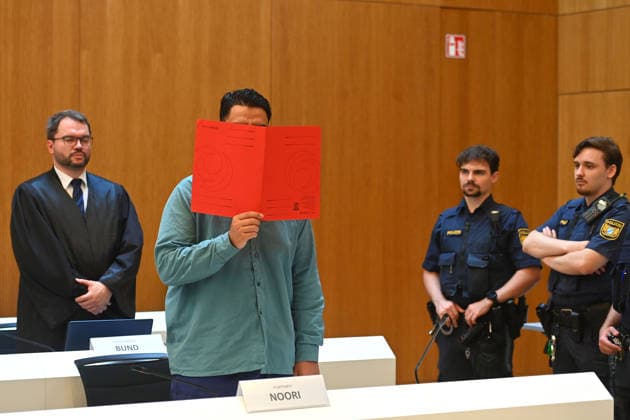 Der Angeklagte im Verhandlungssaal, verbirgt sein Gesicht hinter einem Schnellhefter.Hinten:sein Verteidiger RA Johann BUND. Urteil im Strafverfahren gegen Farhad Noori wegen Mordes u.a.(Seidlstrasse) am 06.08.2026 vor dem Oberlandesgericht Muenchen *** The defendant in the courtroom hides his face behind a binder; behind him stands his defense attorney, Johann BUND. Verdict in the criminal case against Farhad Noori for murder, among other charges, on Seidlstrasse on August 6, 2026, before the Munich Higher Regional Court.