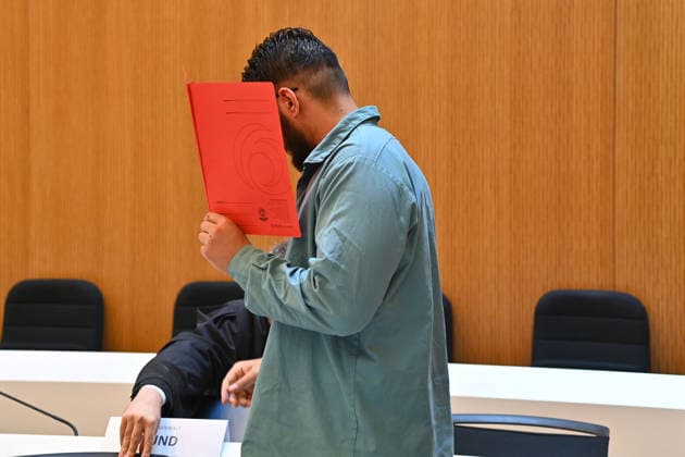 Der Angeklagte im Verhandlungssaal, verbirgt sein Gesicht hinter einem Schnellhefter. Urteil im Strafverfahren gegen Farhad Noori wegen Mordes u.a.(Seidlstrasse) am 06.08.2026 vor dem Oberlandesgericht Muenchen *** The defendant in the courtroom hides his face behind a binder. Judgment in the criminal case against Farhad Noori for murder, among other charges, on Seidlstrasse on August 6, 2026, before the Munich Higher Regional Court