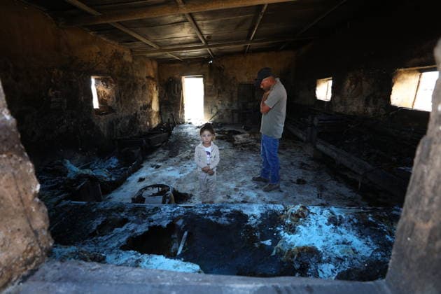 Homes burned, residents injured in Israeli settlers attack on Masafer Yatta community HEBRON, WEST BANK, PALESTINE - AUGUST 6: A Palestinian man and a girl stand inside a home damaged in an attack by Israeli settlers in the Khirbet al-Tuba community in the Masafer Yatta area, south of Hebron, West Bank, Palestine on August 6, 2026. Six Palestinians, including three women, were injured and several homes were set ablaze in the attack. Wisam Hashlamoun Anadolu Hebron West Bank. Editorial use only. Please get in touch for any other usage.  Copyright: x2026xAnadoluxWisamxHashlamounx