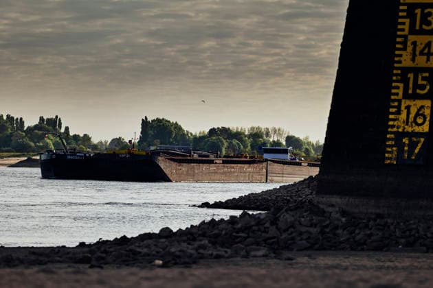 August 6, 2026, Nijmegen, Gelderland, Netherlands: Looking upstream towards GERMANY from under the WAALBRUG near NIJMEGEN, cargo barges sail along the WAAL past the water level gauge on the bridge pillar, which clearly shows the critically low water. This main Dutch branch of the RHINE is experiencing historic low levels due to prolonged drought, forcing inland vessels to operate with sharply reduced loads.Credit : ZUMA Press Nijmegen Netherlands - ZUMAv145 20260806_zip_v145_001 Copyright: xNorbertxVoskensx