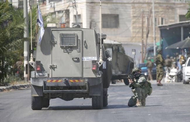 August 6, 2026, Nablus, Palestine: An Israeli soldier takes position during a military operation in neighborhoods of the Askar refugee camp east of Nablus in the West Bank. The raid is part of a broader military campaign targeting refugee camps in the West Bank. The Israeli government has threatened to occupy refugee camps, in areas under the control of Palestinian President Mahmoud Abbas. Nablus Palestine - ZUMAs197 20260806_aaa_s197_096 Copyright: xNasserxishatyehx