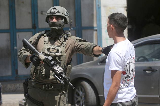 August 6, 2026, Nablus, Palestine: An Israeli soldier stops a Palestinian boy during a military operation in neighborhoods of the Askar refugee camp east of Nablus in the West Bank. The raid is part of a broader military campaign targeting refugee camps in the West Bank. The Israeli government has threatened to occupy refugee camps, in areas under the control of Palestinian President Mahmoud Abbas. Nablus Palestine - ZUMAs197 20260806_aaa_s197_103 Copyright: xNasserxishatyehx