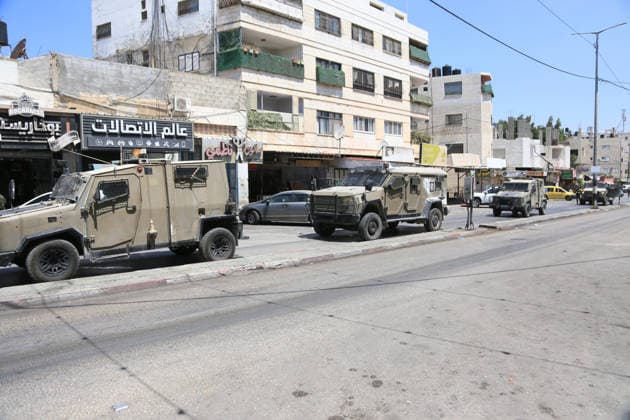August 6, 2026, Nablus, Palestine: Israeli military vehicles are stationed along the street in the middle of the market in Askar refugee camp, east of Nablus in the West Bank. The raid is part of a broader military campaign targeting refugee camps in the West Bank. The Israeli government has threatened to occupy refugee camps, in areas under the control of Palestinian President Mahmoud Abbas. Nablus Palestine - ZUMAs197 20260806_aaa_s197_114 Copyright: xNasserxishatyehx