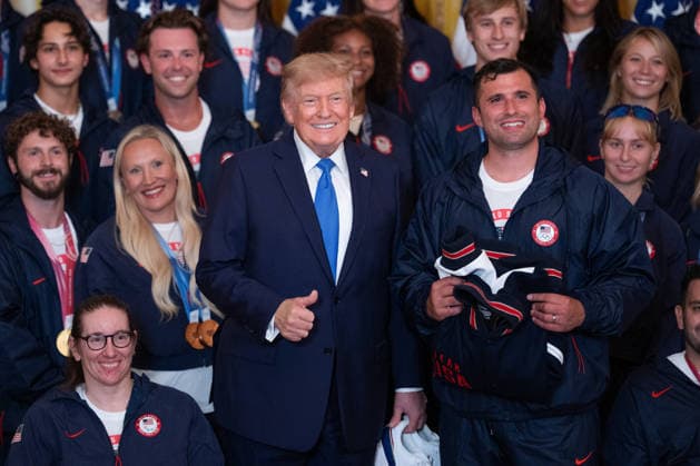 President Trump Hosts Team USA Olympians at White House United States President Donald J Trump poses for a photo with U.S. Olympic athletes in the East Room of the White House in Washington, DC, USA, on Thursday, August 6, 2026. President Trump is hosting a ceremony for Team USA Olympians who competed in the 2026 Olympic Winter Games in Italy. Credit: Aaron Schwartz Pool via CNP Washington District of Columbia United States  Copyright: xPool ABACAx