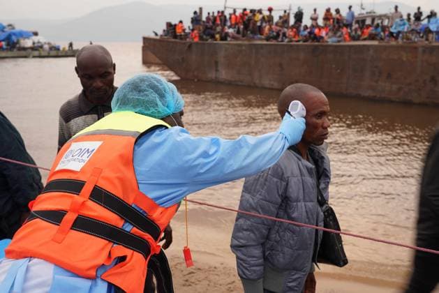 (260807) -- KINSHASA, Aug. 7, 2026 () -- A staff member of the International Organization for Migration (IOM) takes temperature of a passenger from an intercepted boat outside Kinshasa, capital of the Democratic Republic of the Congo (DRC), Aug. 6, 2026. Health authorities in the DRC have intercepted a passenger boat outside Kinshasa following the death of a former passenger suspected of having Ebola, officials said Wednesday. () DR CONGO-KINSHASA-PASSENGER BOAT-EBOLA CASE Xinhua 