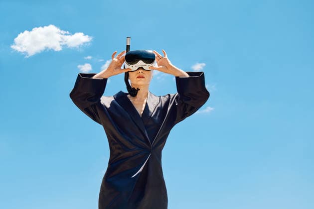 Woman holds virtual reality snorkel mask against blue sky model released, Symbolfoto, CATF01116
