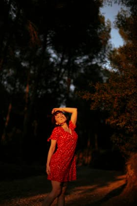 A woman enjoys the golden hour sunlight in a calm forest model released, Symbolfoto, GMLF02296