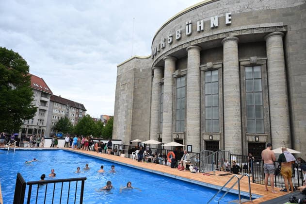 Temporary swimming pool opened in front of the Volksbuehne theatre in Berlin BERLIN, GERMANY - AUGUST 07: People swim and visit the newly opened Volksbad, a temporary public swimming pool installed in front of the Volksbuehne theatre at Rosa-Luxemburg-Platz in Berlin, Germany, on August 07, 2026. To mark the start of the Volksbuehne’s new artistic directorship, a temporary public swimming pool with a 25-meter swimming lane has been installed on the square for eight weeks. Volodymyr Sindieiev Anadolu Berlin Germany. Editorial use only. Please get in touch for any other usage.  Copyright: x2026xAnadoluxVolodymyrxSindieievx