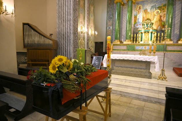 Flowers lay on the coffin of Polish volunteer Marek Rusek-Wolski, who was killed near Kharkiv by a Russian drone attack, during the farewell ceremony at the Cathedral of St Alexander in Kyiv, Ukraine, August 7, 2026. The tragedy occurred at the end of July (approximately 27 July) near Kharkiv, when the volunteer came under a targeted Russian drone strike while on a humanitarian mission. Marek Rusek-Wolski was an administrator of the Polish volunteer community Razem dla Ukrainy. Since early 2023, he had been regularly travelling to Ukraine. He used to organise fundraisers, purchase and deliver food, medicines, hygiene products and animal feed to the most dangerous front-line settlements in the Kharkiv region. (Photo by Yevhen Kotenko Ukrinfo  Copyright: xYevhenxKotenkox
