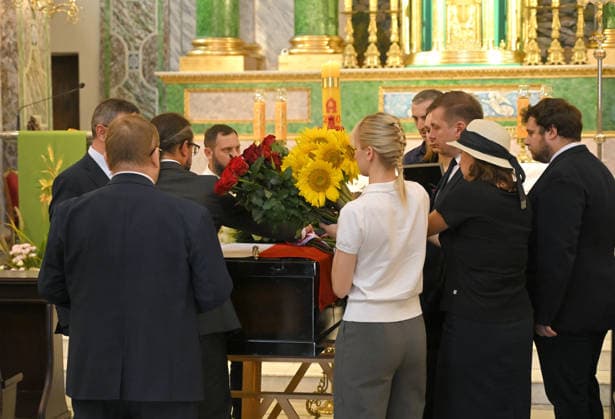 People lay flowers on the coffin of Polish volunteer Marek Rusek-Wolski, who was killed near Kharkiv by a Russian drone attack, during the farewell ceremony at the Cathedral of St Alexander in Kyiv, Ukraine, August 7, 2026. The tragedy occurred at the end of July (approximately 27 July) near Kharkiv, when the volunteer came under a targeted Russian drone strike while on a humanitarian mission. Marek Rusek-Wolski was an administrator of the Polish volunteer community Razem dla Ukrainy. Since early 2023, he had been regularly travelling to Ukraine. He used to organise fundraisers, purchase and deliver food, medicines, hygiene products and animal feed to the most dangerous front-line settlements in the Kharkiv region. (Photo by Yevhen Kotenko  Copyright: xYevhenxKotenkox