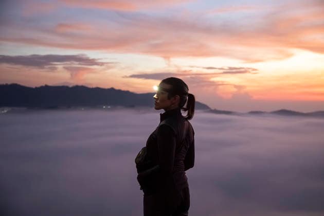 Person with headlamp standing on mountain summit at sunrise in Java model released, Symbolfoto, PNAF06791