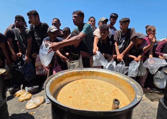 Palestinians Queue for Food in Southern Gaza Palestinians wait in line to receive a meal from a charity kitchen in Al-Mawasi, Khan Younis, southern Gaza Strip, on August 7, 2026, amid the ongoing humanitarian crisis and shortages of food supplies. Photo by Tariq Mohammad APA Images Khan Yunis Gaza Strip Palestinian Territory 070826_Khan_Yunis_TM_00(16) Copyright: xapaimagesxTariqxMohammad xapaimagesx