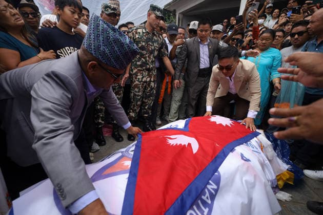 Funeral Held For Record Holding Nepali Climber Pur Bahadur Gurung- -Yukta- Killed In Broad Peak Avalanche With Honors Nepali Home Minister Sudhan Gurung, wearing glasses, drapes the body of Nepali mountaineer Pur Bahadur Gurung (Yukta) with Nepal s national flag ahead of his funeral in Kathmandu, Nepal, on August 7, 2026. Pur Bahadur Gurung died during an expedition on Pakistan s 8,047-metre Broad Peak in July 2026. The cremation took place at Swayambhu in the presence of family members, relatives, Home Minister Sudhan Gurung, Nepali Congress President Gagan Thapa, members of the mountaineering community and well-wishers. The funeral was led by shamans who performed rituals after circumnavigating the Swayambhunath Stupa, a UNESCO World Heri  Copyright: xSubaasxShresthax originalFilename: shrestha-funeralh260807_npamh.jpg