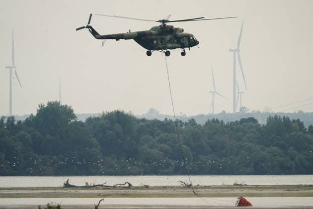 August 7, 2026, Sumarak, Vojvodina, Serbia: 202687, Sumarak, Serbia - Thick smoke rises above the landscape as a massive wildfire burns through the Deliblato Sands (Deliblatska Pescara) Special Nature Reserve. Helicopters of the Serbian Armed Forces are deployed to combat the blaze, using Bambi buckets to fetch water and extinguish the fire from the air. Deliblato Sands, often referred to as the European Sahara, is a strictly protected natural area. Sumarak Serbia  - ZUMAd223 20260807_zip_d223_008 Copyright: xMarkoxDimicx
