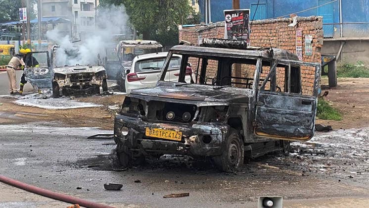 PATNA, INDIA - AUGUST 7: Police vehicles set ablaze by an angry mob after a speeding bus struck and fatally ran over a 22-year-old local resident Manish Kumar along National Highway 30 near the Zero Mile intersection under the Agamkuan police station limits on August 7, 2026 in Patna, India. Incensed by the fatal hit-and-run incident, angry residents and eyewitnesses staged a road blockade, vandalized passing vehicles including public transport bus, three police vehicles, and several two-wheelers. The mob also pelted stones at responding law enforcement teams.(Photo by Santosh Kumar Hindustan Times) Angry Mob Torches Bus, Police Vehicles After Youth Killed by Speeding Bus In Patna