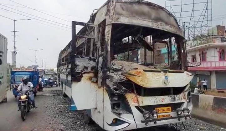 PATNA, INDIA - AUGUST 7: A public transport bus set ablaze by an angry mob after a speeding bus struck and fatally ran over a 22-year-old local resident Manish Kumar along National Highway 30 near the Zero Mile intersection under the Agamkuan police station limits on August 7, 2026 in Patna, India. Incensed by the fatal hit-and-run incident, angry residents and eyewitnesses staged a road blockade, vandalized passing vehicles including public transport bus, three police vehicles, and several two-wheelers. The mob also pelted stones at responding law enforcement teams.(Photo by Santosh Kumar Hindustan Times) Angry Mob Torches Bus, Police Vehicles After Youth Killed by Speeding Bus In Patna