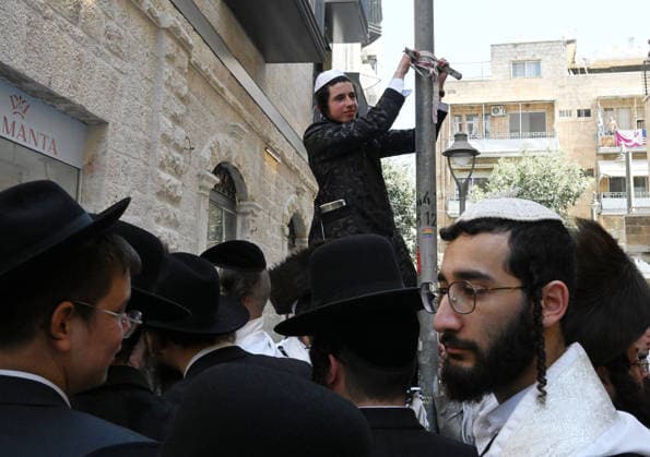 Ultra-Orthodox Jews protest against Cafe Basimta for being open on the Jewish Sabbath, Saturday, in central Jerusalem, August 8, 2026. Few cafes and restaurants are open from dusk on Friday until dusk on Saturday in observance of the Sabbath in Jerusalem.  JER2026080804 DEBBIExHILL