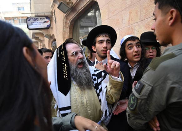 Israeli border police stop Ultra-Orthodox Jews from reaching Cafe Basimta during a protest against the cafe being open on the Jewish Sabbath, Saturday, in central Jerusalem, August 8, 2026. Few cafes and restaurants are open from dusk on Friday until dusk on Saturday in observance of the Sabbath in Jerusalem.  JER2026080807 DEBBIExHILL