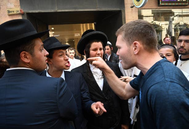A secular Israeli argues with Ultra-Orthodox Jews protesting against Cafe Basimta for being open on the Jewish Sabbath, Saturday, in central Jerusalem, August 8, 2026. Few cafes and restaurants are open from dusk on Friday until dusk on Saturday in observance of the Sabbath in Jerusalem.  JER2026080814 DEBBIExHILL