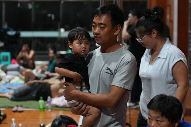 (260808) -- TAIZHOU, Aug. 8, 2026 -- Residents are pictured at a temporary shelter in a middle school in Yuhuan, Taizhou City, east China s Zhejiang Province, Aug. 8, 2026. Coastal areas of eastern China were bracing for strong winds and torrential rain as Typhoon Dolphin approached, prompting authorities to recall fishing boats, suspend ferry services and prepare for evacuations. China s meteorological authority on Saturday upgraded its emergency response for Dolphin to Level III and raised the typhoon warning from yellow to orange. ) CHINA-ZHEJIANG-TYPHOON DOLPHIN-PREVENTION (CN) HuangxZongzhi 
