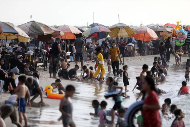 Palestinian families seek respite from summer heat on Gaza beach Palestinian families gather on the beach in Gaza City to escape the summer heat and spend time by the sea, as tents sheltering displaced Palestinians line the coast, on August 8, 2026. Residents seek moments of rest amid difficult living conditions caused by the war. Photo by Bilal Osama apaimages Gaza city Gaza Strip Palestinian Territory 080826_Gaza_BO_02(18) Copyright: xapaimagesxBilalxOsamax xapaimagesx