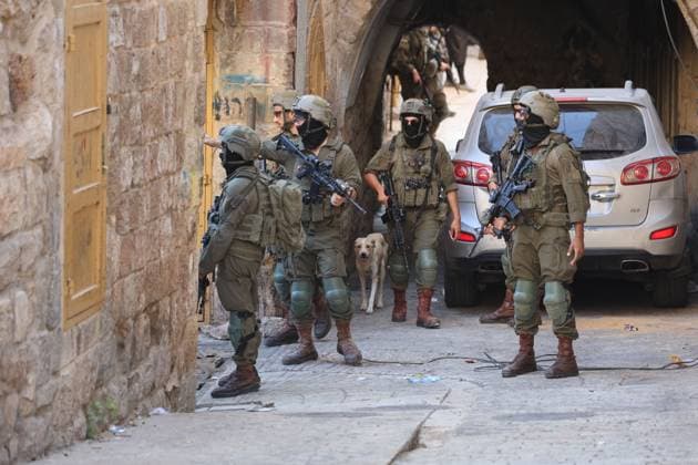 August 8, 2026, Hebron, Palestine, State of: HEBRON, Palestine Ã¢â‚¬ August 8, 2026: A Palestinian family sits inside their vehicle after it was stopped during a settler incursion in the Old City of Hebron, as Israeli forces secure the area. The incident occurred amid heightened tensions and increased settler activity in the historic city. Hebron Palestine, State of - ZUMAq101 20260808_zna_q101_079 Copyright: xMosabxShawerx