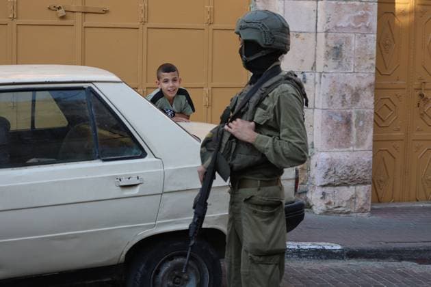 August 8, 2026, Hebron, Palestine, State of: HEBRON, Palestine Ã¢â‚¬ August 8, 2026: A Palestinian family sits inside their vehicle after it was stopped during a settler incursion in the Old City of Hebron, as Israeli forces secure the area. The incident occurred amid heightened tensions and increased settler activity in the historic city. Hebron Palestine, State of - ZUMAq101 20260808_zna_q101_084 Copyright: xMosabxShawerx
