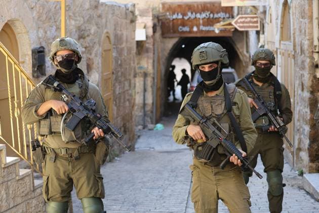 August 8, 2026, Hebron, Palestine, State of: HEBRON, Palestine Ã¢â‚¬ August 8, 2026: A Palestinian family sits inside their vehicle after it was stopped during a settler incursion in the Old City of Hebron, as Israeli forces secure the area. The incident occurred amid heightened tensions and increased settler activity in the historic city. Hebron Palestine, State of - ZUMAq101 20260808_zna_q101_105 Copyright: xMosabxShawerx