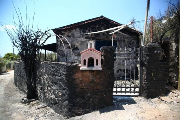 August 8, 2026, Porto Germeno, Greece: PORTO GERMENO, Greece Ã¢â‚¬ August 8, 2026: Five days after a wildfire swept through Porto Germeno, burned forests, damaged homes, and destroyed property remain across the affected area. With most residents evacuated, workers and emergency personnel continue clearing damaged areas, restoring infrastructure, and monitoring the fire-scarred landscape. Photos by JNA Press. Porto Germeno Greece - ZUMAq101 20260808_zna_q101_167 Copyright: xHarrisxXanthopoulosx