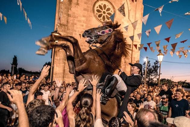 August 8, 2026, Llucmacanes, Menorca Balearic Islands, Spain: A caixer, or horse rider, rears his horse amid a cheering crowd during the traditional Jaleo at the Sant Gaieta Festival in Llucmacanes Llucmacanes Spain - ZUMAo105 20260808_fap_o105_001 Copyright: xMatthiasxOesterlex